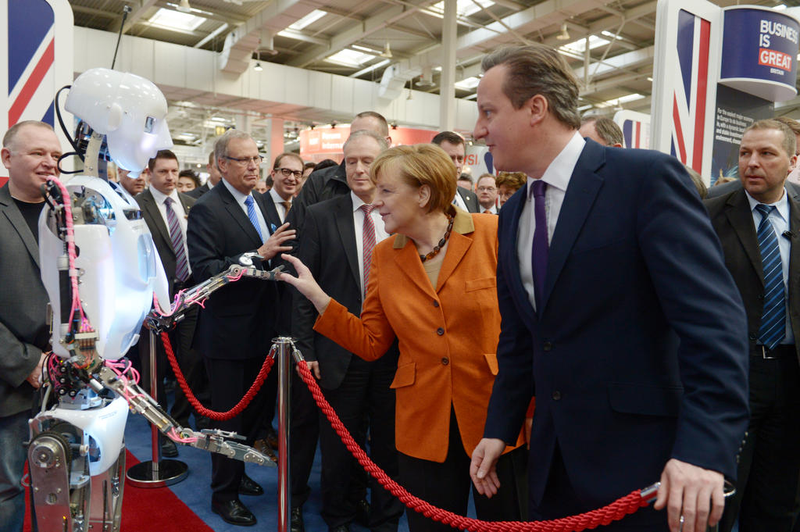 Illustration for article titled Why Is Angela Merkel Always Palling Around With Robots?